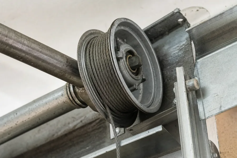 Lift cable wound onto its drum above a garage door in Kansas City, MO