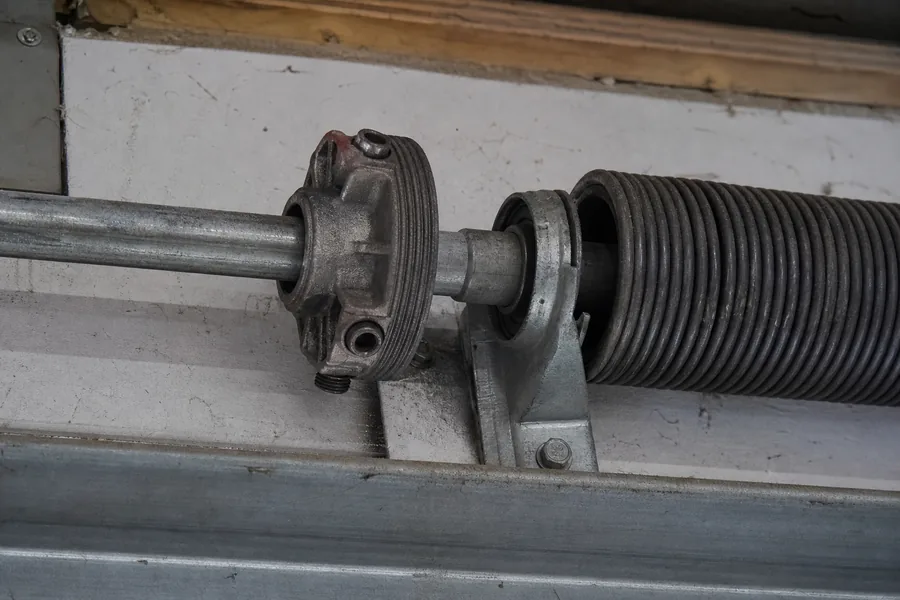 Torsion spring, winding cone and center bearing above a garage door in Kansas City, MO
